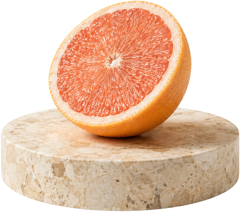 Halved grapefruit on a stone disc